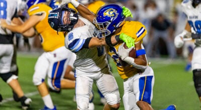 Barbe's Jack Sonnier tackles Sulphur's Tyler Joubert on Friday, Nov. 1, 2024, at Matt Walker Memorial Stadium in Sulphur. (Rodrick Anderson / American Press)