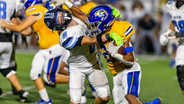 Barbe's Jack Sonnier tackles Sulphur's Tyler Joubert on Friday, Nov. 1, 2024, at Matt Walker Memorial Stadium in Sulphur. (Rodrick Anderson / American Press)